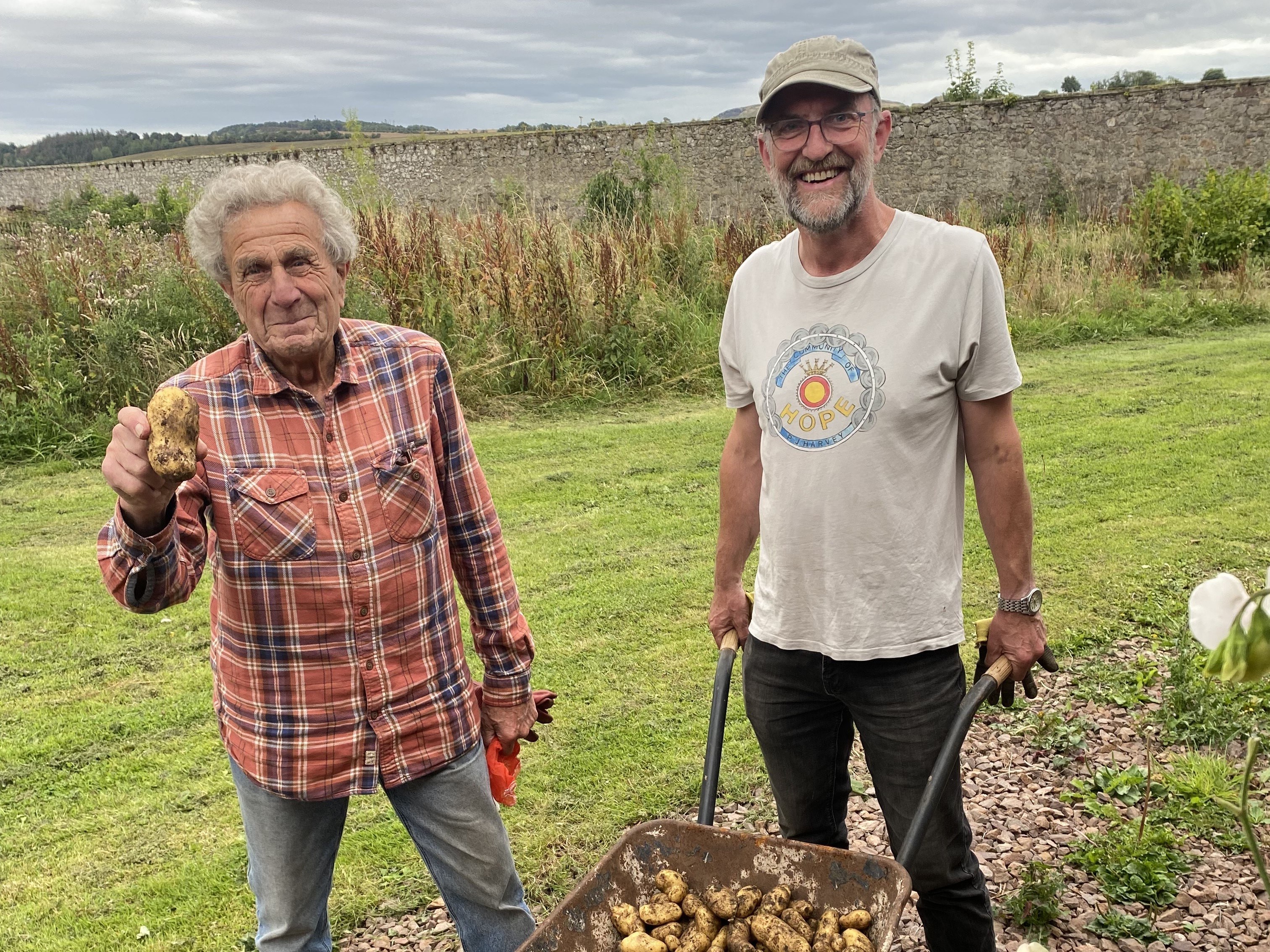 Volunteers Harald and Gary harvesting potatoes at Gilmerton House Walled Garden